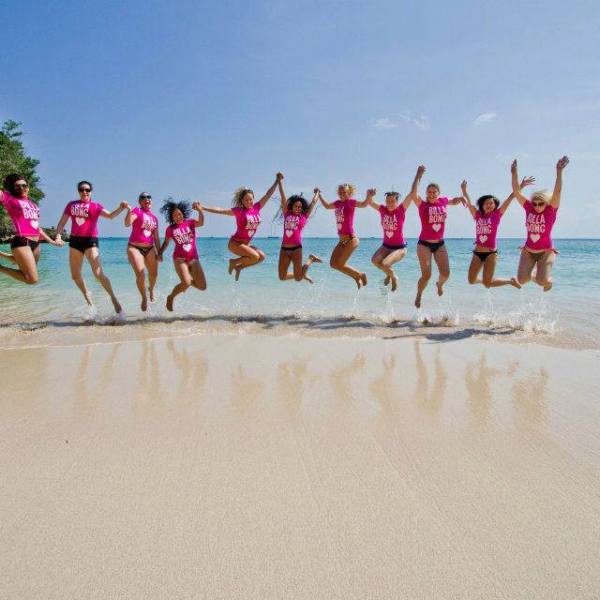 Billabong ladies jumping on a beach