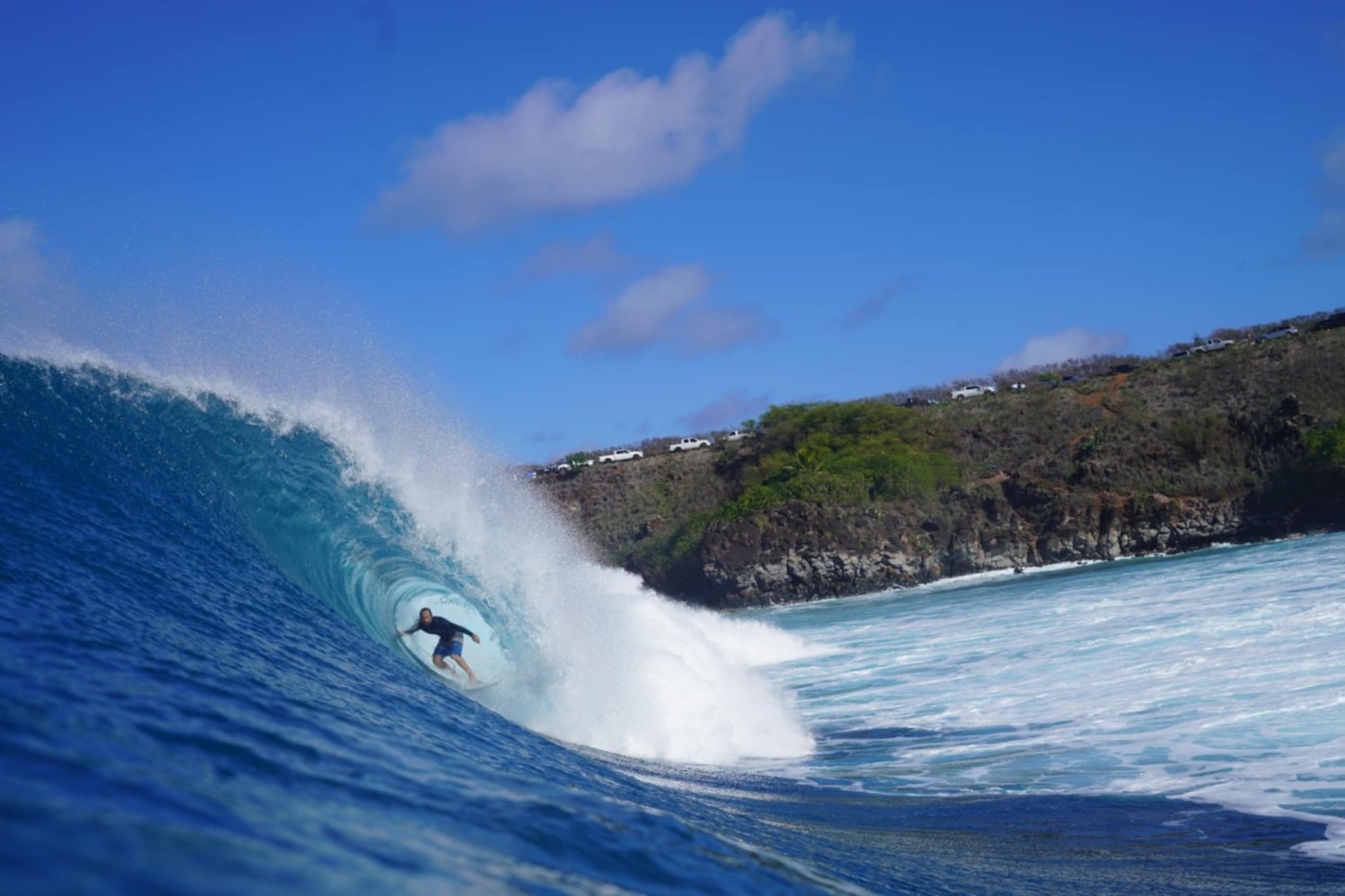 a man riding a wave on top of a mountain