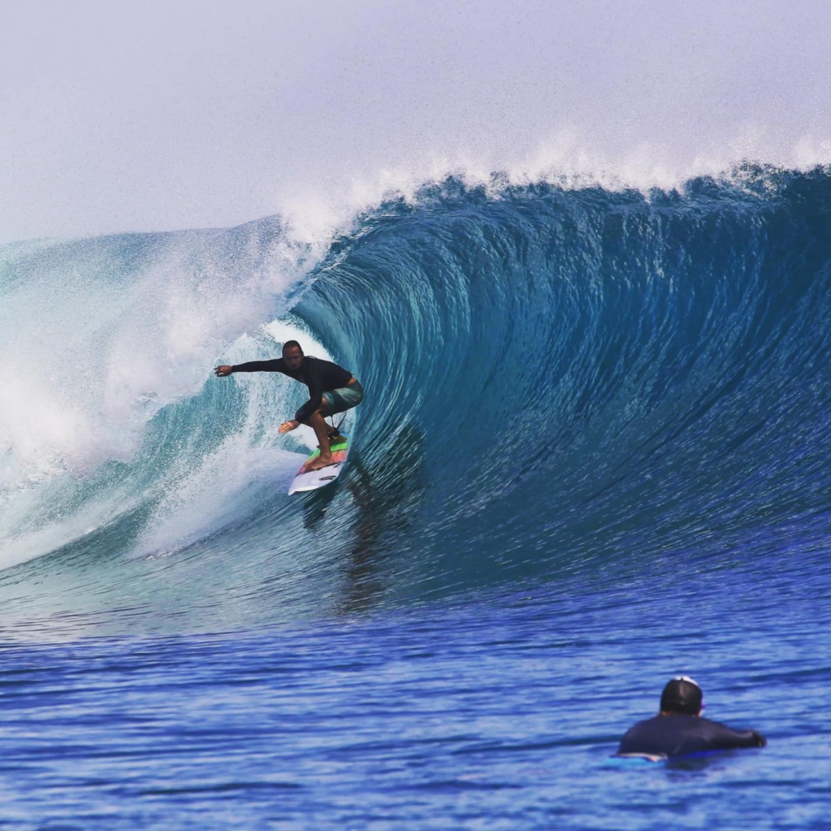 a man riding a wave on a surfboard in the ocean