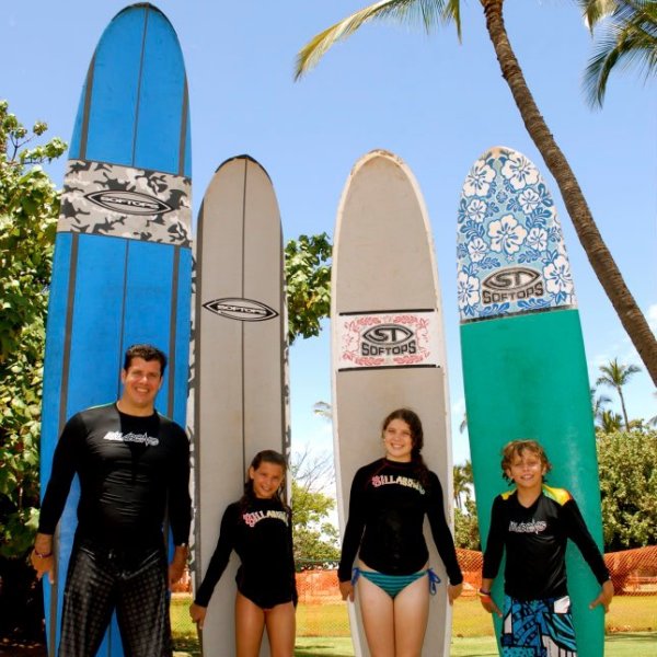 a group of people standing on a beach posing for the camera