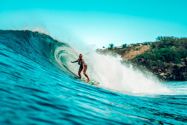 a man riding a wave on a surfboard in the water