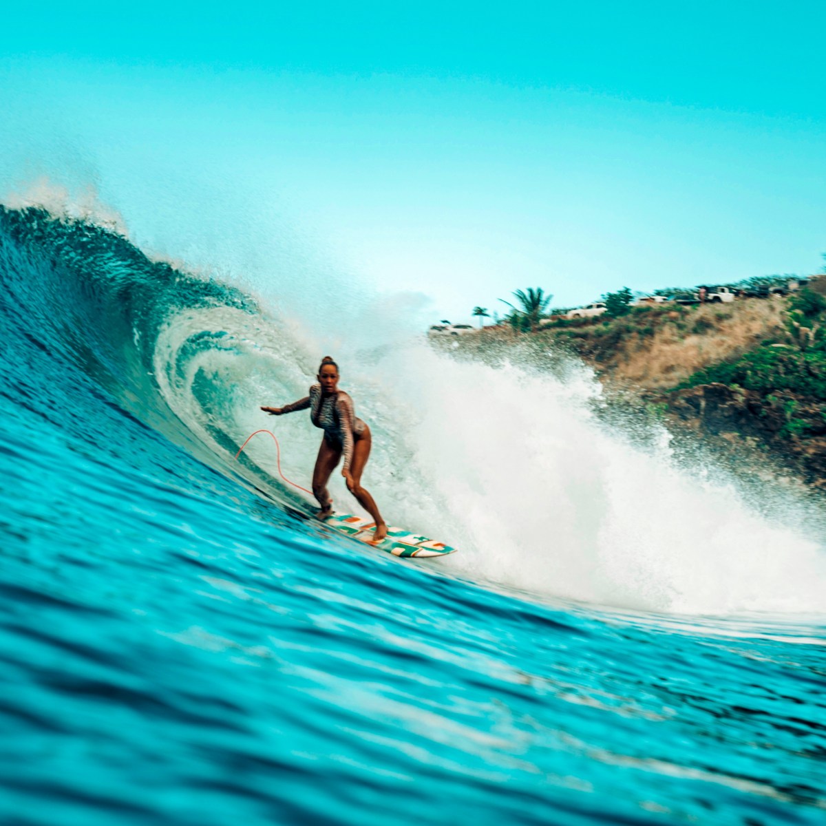 a man riding a wave on a surfboard in the water